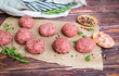 Beef raw meatballs on wooden background 