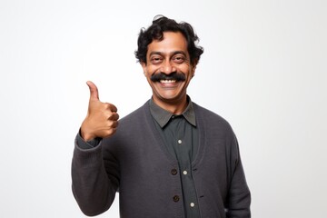 Poster - Portrait of a smiling indian man in his 40s showing a thumb up isolated in white background