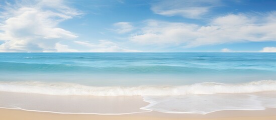 Poster - The scenic beach and tranquil blue sea with gentle waves blend harmoniously with the sky adorned in white clouds creating an idyllic seascape backdrop This copy space image is perfect for conveying t