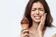 Teeth Sensitive to Cold concept. woman hold Ice cream and having toothache and pain after eat