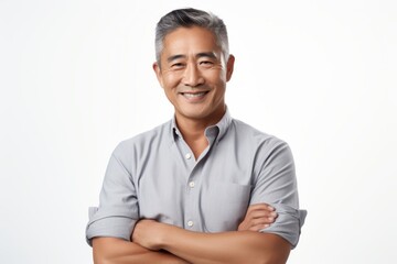 Wall Mural - Portrait of a grinning asian man in his 50s with arms crossed in white background