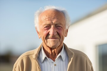 Wall Mural - Portrait of a content man in his 80s smiling at the camera over white background
