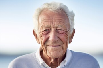 Wall Mural - Portrait of a content man in his 80s smiling at the camera isolated in white background