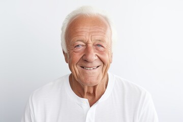Wall Mural - Portrait of a content man in his 70s smiling at the camera isolated in white background