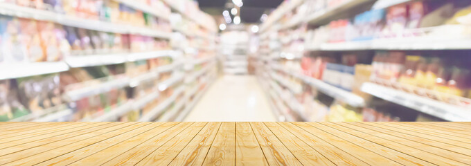 Wall Mural - Empty wood table top with supermarket blurred background for product display