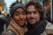 © Georgii - Young interracial couple smiling in a cozy outdoor setting, close-up portrait