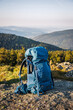 Hiking backpack with tripod during trekking in mountains. Hike and travel outdoor equipment
