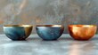 Unique Handcrafted Copper and Blue Patina Bowls on Textured Surface.