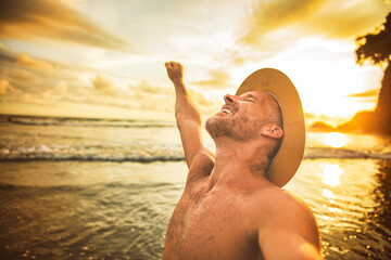 Wall Mural - nice man taking selfie portrait on beach