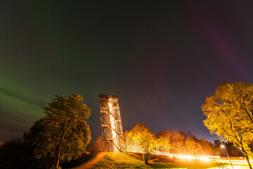 Wall Mural - Aurora borealis, The Northern lights over watching tower. Kuldiga, Latvia.