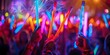 © Anastasiia - Hands holding glow sticks at rave with blurred dancing crowd in the background. Concept Rave Photography, Glow Sticks, Blurred Crowd, EDM Festival, Nightlife Scenes
