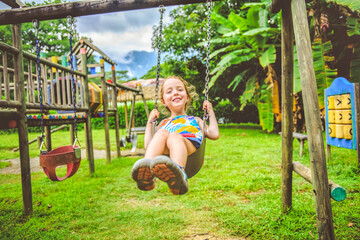 Wall Mural - Active little girl having fun on playground