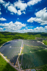 Solar panel produces green, environmentaly friendly energy from the setting sun. Aerial view from drone. Landscape picture of a solar plant that is located inside a valley
