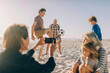 © Marko Geber - Multigenerational family having fun playing soccer on the beach