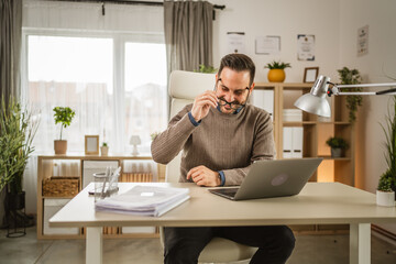 Wall Mural - One adult man sit at office put his eyeglasses and prepare for workday