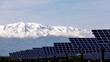© ADDICTIVE STOCK - Solar panels with snow-capped mountains in the background
