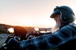 © ADDICTIVE STOCK - Senior man enjoying a sunset ride on his motorcycle