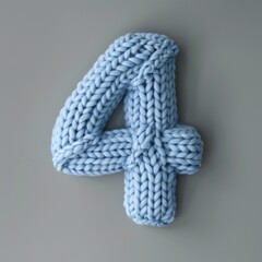 Wall Mural - A knitted number 4 in blue color on the gray background.