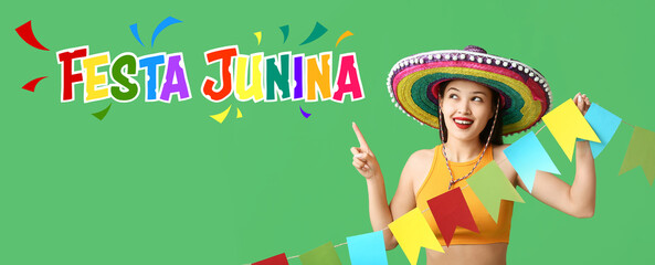 Poster - Happy young woman in Mexican sombrero hat and with garland pointing at something on green background