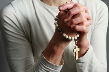 Wall Mural - praying to god with cross and hands together with black background with people stock image stock photo