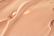 Makeup foundation blur cream as background, top view. Texture of liquid foundation.