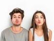 © VISUAL BACKGROUND - Young couple making funny faces.