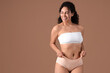 © Pixel-Shot - Young African-American woman in menstrual panties on brown background