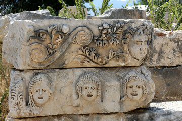Wall Mural - Stone faces bas relief at Myra ancient city. Demre, Turkey masks and Lycian tombs in the Myra, Turkey historical site