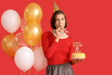 Canvas Print - Beautiful woman in party hat with cake and balloons celebrating Birthday on red background