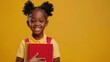 © VizGen - A Cute Smiling Little African American Schoolgirl Held Books On A Yellow Background, Ready For A Day Of Learning,High Resolution