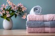 Three Towels Stacked on Wooden Table