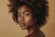 © Andrei - portrait of an african american beautiful girl with fluffy hair on a beige background. Beauty concept and beauty