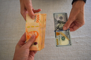 exchanging US dollars for Argentine pesos, symbol for inflation in Argentina