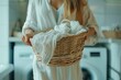 Woman Holding Basket of Laundry in Front of Washing Machine