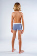 © 3Days2Go Media - Back view of a young long haired boy casually standing wearing striped swim trunks
