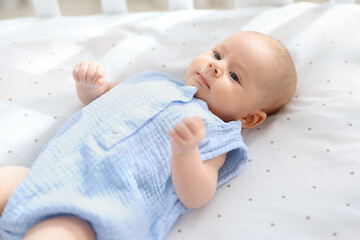 Sticker - Cute little baby lying in crib at home