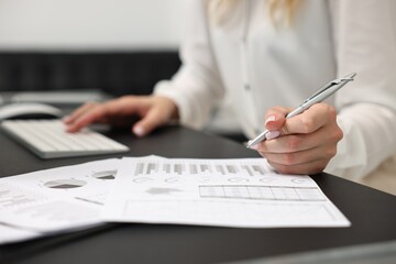 Poster - Secretary working with document at table in office, closeup