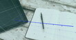Image of arrow on growing graph over laptop, cellphone and digital tablet, pen and notepad