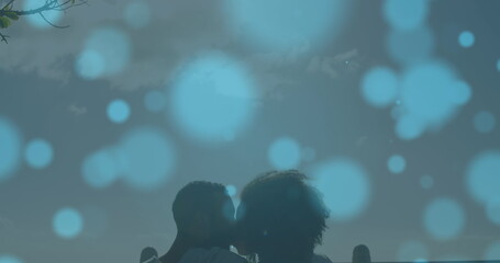 Sticker - Image of light spots over biracial couple kissing