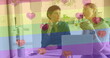 Image of heart emojis and rainbow flag over caucasian female couple using laptop
