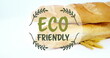 Image of eco friendly text banner against close up of fresh bread and wheat ears