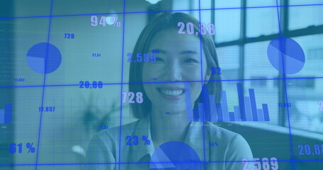 Wall Mural - Image of graphs and changing numbers over smiling asian woman standing beside glass window