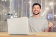Happy young business man using laptop computer