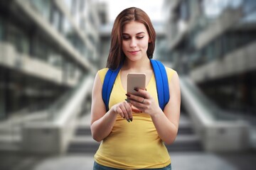 Woman texting on mobile phone outdoors.