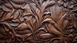 A wooden carving of a leafy design with a brown color