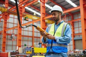 Sticker - worker or engineer operating remote switch to control machine in the factory