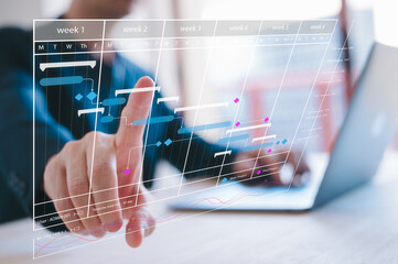 Time management project planning staff working hours concept, Project manager updating tasks and milestones progress planning with Gantt chart scheduling interface on a virtual screen