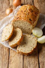 Wall Mural - Homemade fragrant Caramelized Onion Bread closeup on the wooden board on the table. Vertical