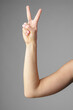 Woman Holding Arm Up in the Air with Gesture