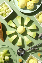 Wall Mural - Ice cream scoops with slices of fresh melon on a green background